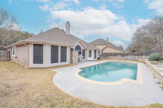 view of swimming pool with a fenced backyard, a yard, a grill, a fenced in pool, and a patio area