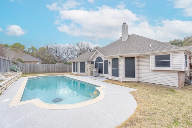 view of pool with a fenced in pool, a lawn, a fenced backyard, and a patio area