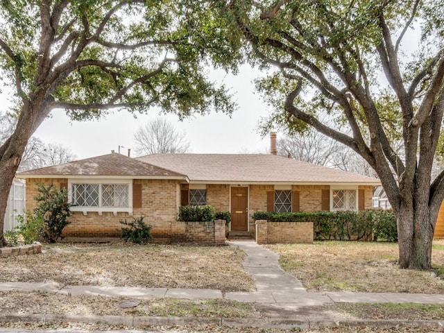 single story home with brick siding and a shingled roof