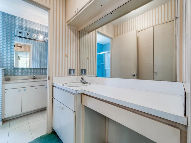 full bath featuring tile patterned floors, vanity, and wallpapered walls