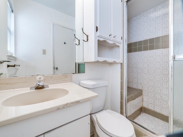 full bathroom featuring vanity, toilet, and a stall shower