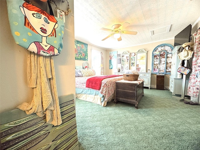 bedroom featuring crown molding, visible vents, carpet floors, and ceiling fan