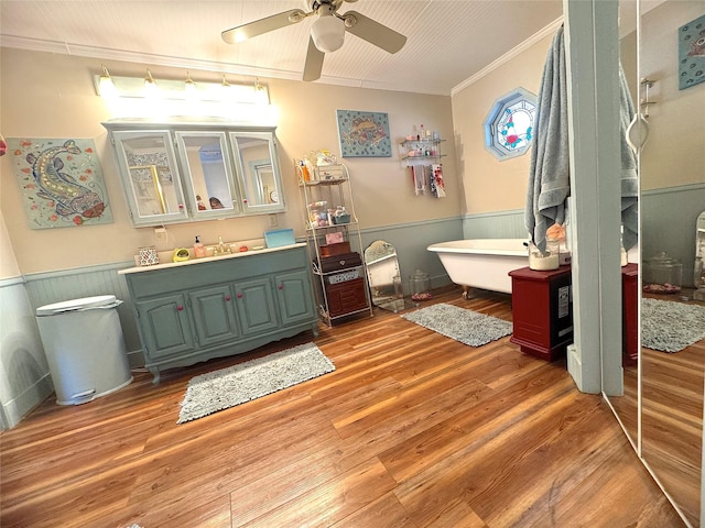 bathroom with vanity, wood finished floors, wainscoting, and ornamental molding