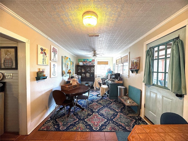 office space featuring visible vents, baseboards, ornamental molding, an ornate ceiling, and a ceiling fan