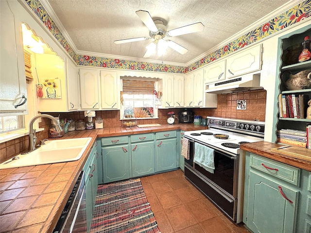 kitchen featuring under cabinet range hood, electric stove, tile counters, and a sink