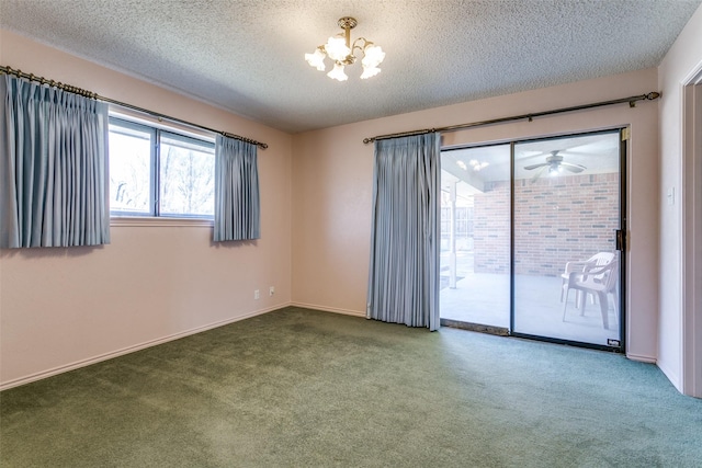 carpeted spare room with a notable chandelier and a textured ceiling