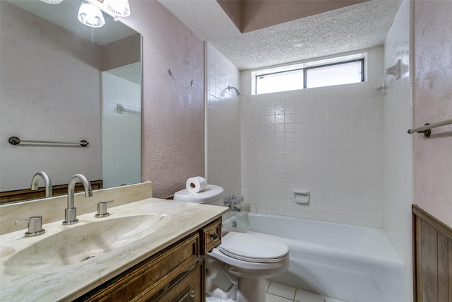 bathroom with toilet, a textured ceiling, bathing tub / shower combination, vanity, and a textured wall