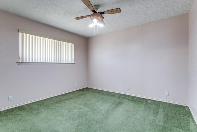 carpeted spare room featuring baseboards, a textured ceiling, and a ceiling fan