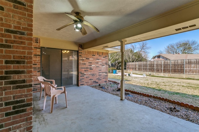 view of patio / terrace featuring fence and ceiling fan