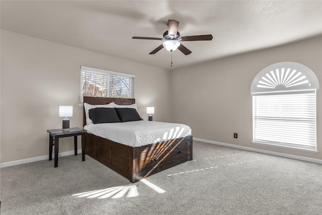 carpeted bedroom with baseboards and ceiling fan