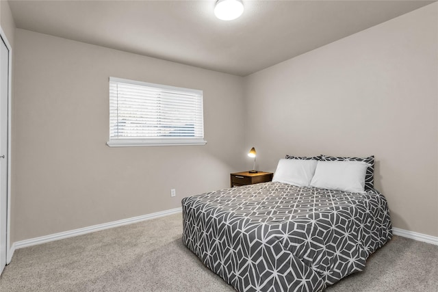 carpeted bedroom with baseboards