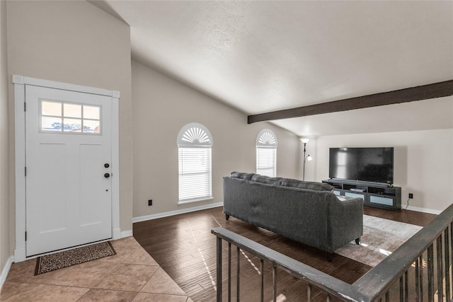 entryway with tile patterned flooring, vaulted ceiling with beams, and baseboards