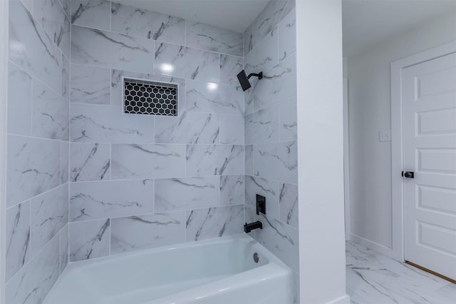 full bath with bathing tub / shower combination and marble finish floor