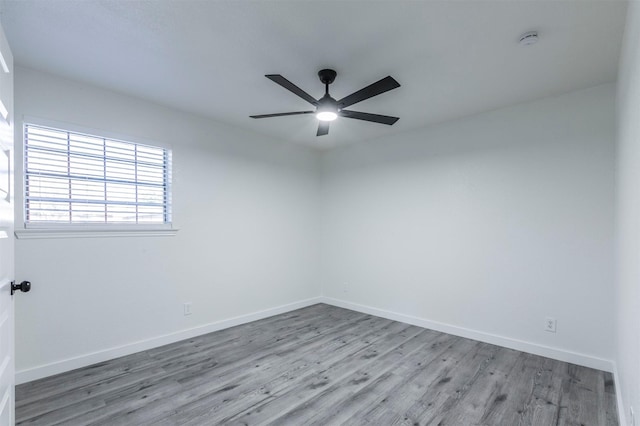 unfurnished room with ceiling fan, baseboards, and wood finished floors