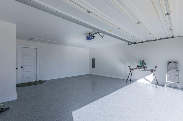 garage with electric panel, a garage door opener, and baseboards