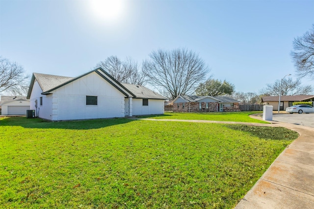 view of yard featuring cooling unit and fence