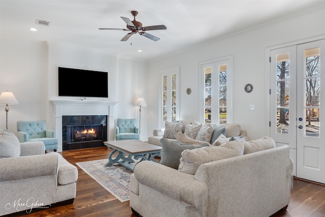 living room featuring dark wood finished floors, recessed lighting, a fireplace, and ornamental molding