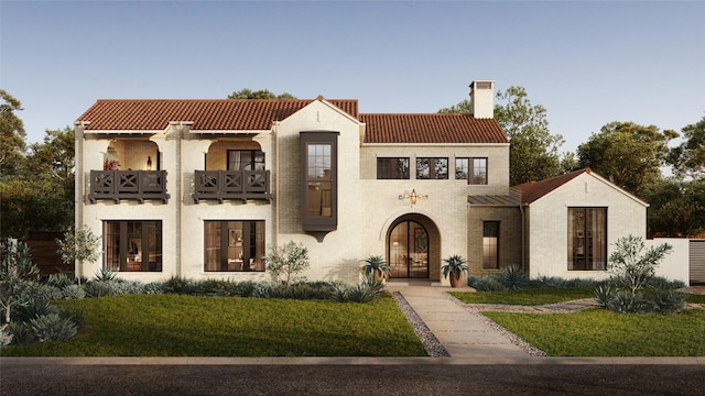 mediterranean / spanish-style home with a tiled roof, a balcony, brick siding, and a chimney