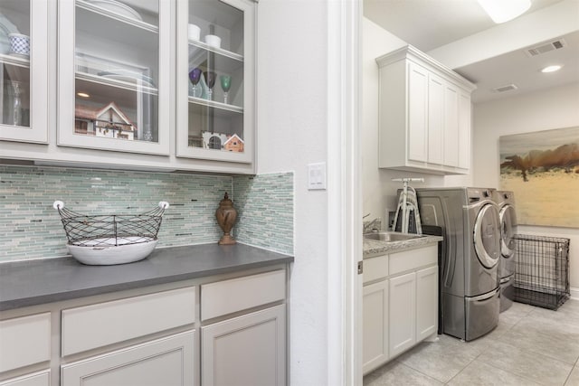 clothes washing area with visible vents, light tile patterned flooring, recessed lighting, cabinet space, and washer and clothes dryer