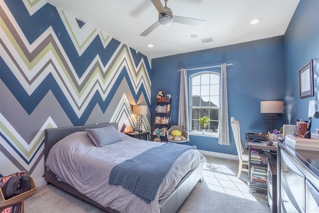 bedroom featuring an accent wall, light colored carpet, visible vents, and wallpapered walls