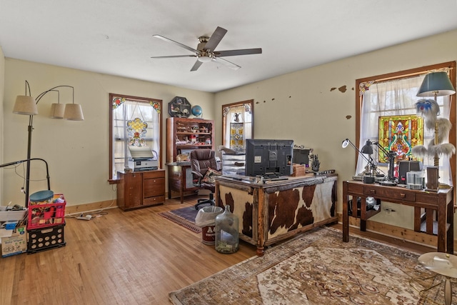 office space with ceiling fan, baseboards, and wood finished floors