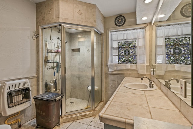 bathroom featuring recessed lighting, heating unit, a shower stall, tile patterned flooring, and vanity