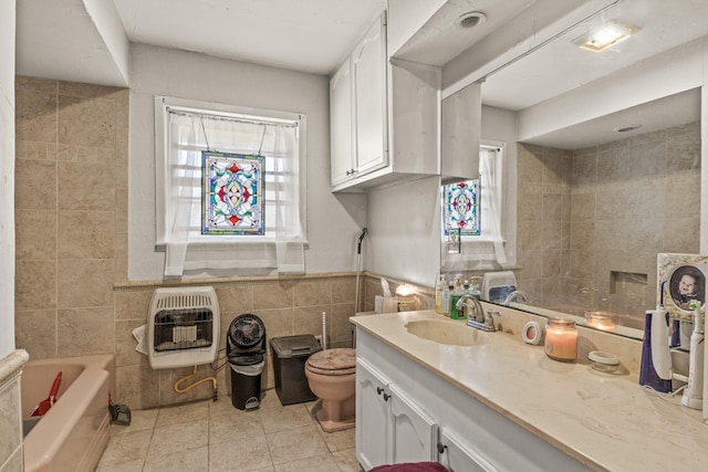 bathroom featuring heating unit, toilet, tile walls, tile patterned floors, and vanity