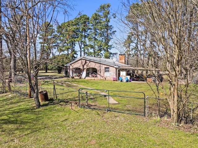 view of yard featuring fence and a gate