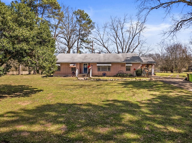 view of front of property with brick siding and a front lawn