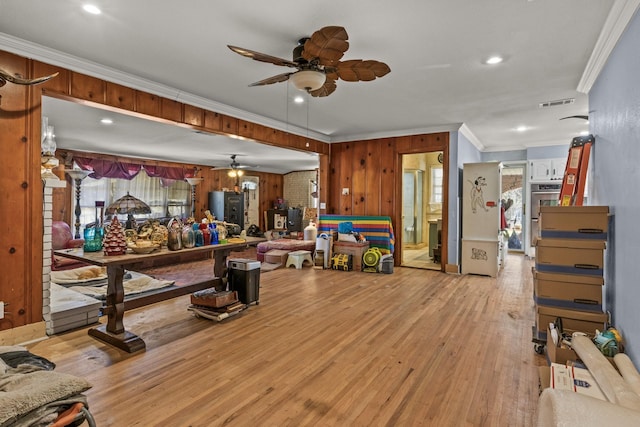 living area featuring wood finished floors, visible vents, recessed lighting, ceiling fan, and ornamental molding