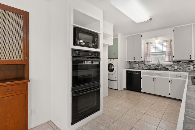 kitchen with decorative backsplash, black appliances, white cabinetry, and a sink