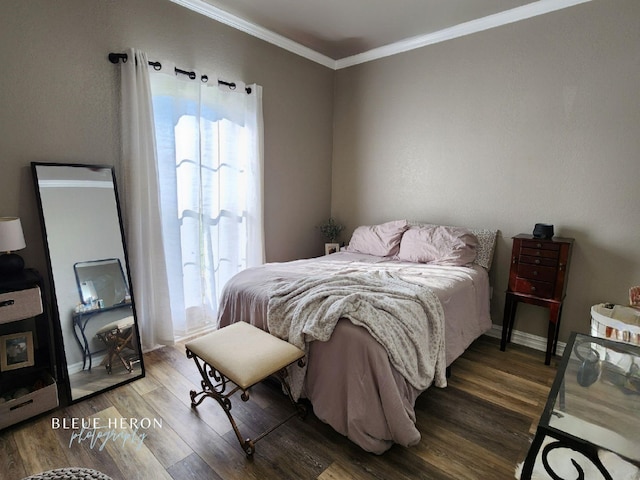 bedroom featuring crown molding, baseboards, and wood finished floors