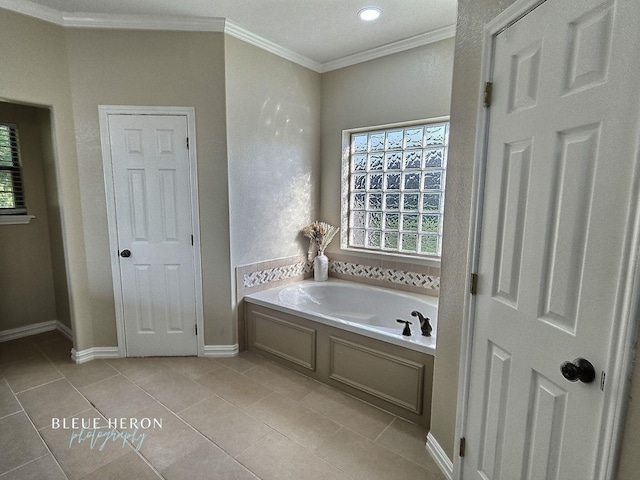 full bathroom with a bath, tile patterned flooring, crown molding, and baseboards