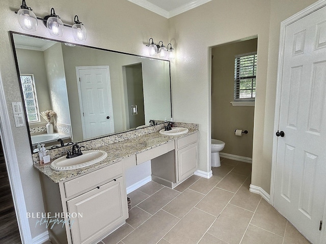 bathroom featuring tile patterned flooring, crown molding, double vanity, and a sink