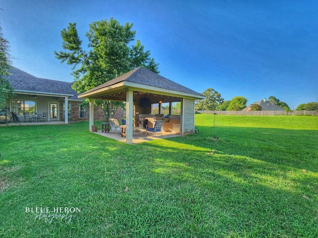 view of yard featuring a gazebo, a patio area, and fence