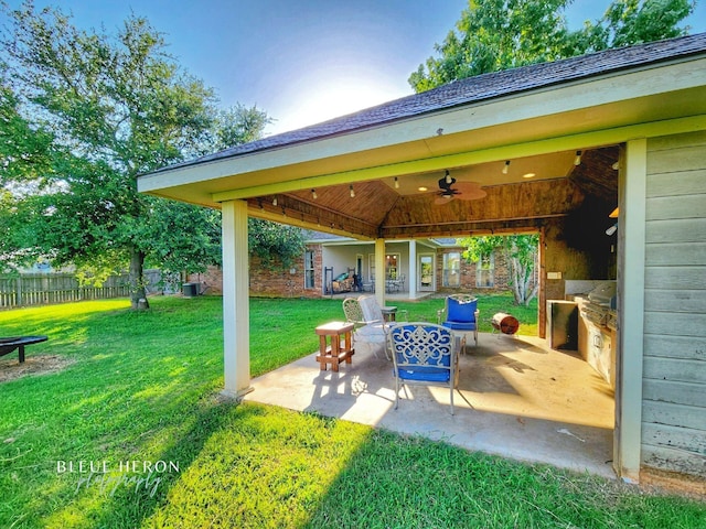 view of patio with ceiling fan and fence