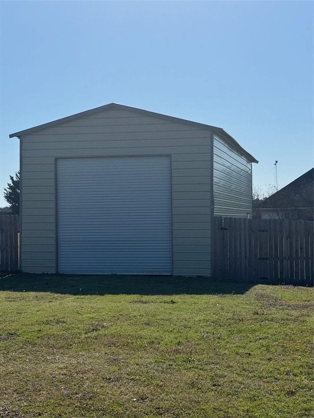 detached garage with driveway and fence