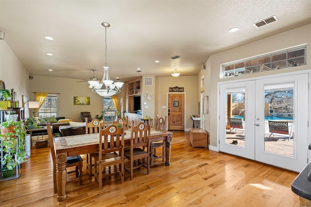 dining space with visible vents, recessed lighting, french doors, and light wood-type flooring