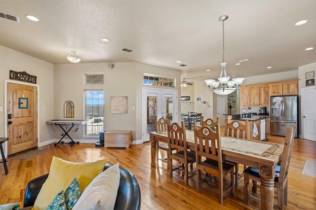 dining room with visible vents, light wood-type flooring, french doors, and baseboards