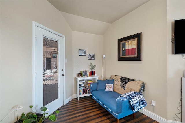 living area with baseboards, dark wood-type flooring, and vaulted ceiling