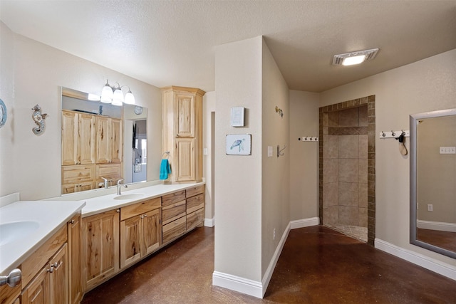 bathroom with a walk in shower, baseboards, finished concrete floors, vanity, and a textured ceiling