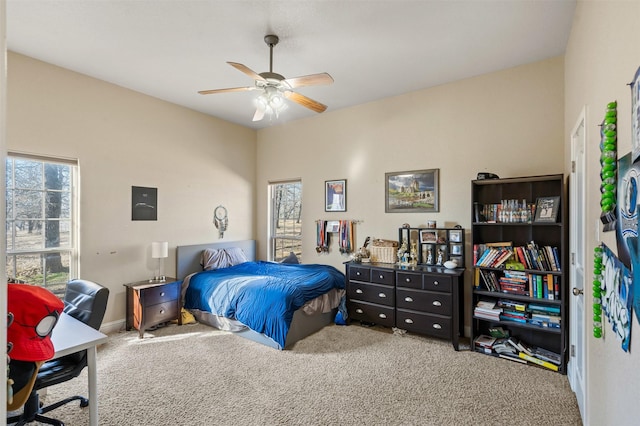 carpeted bedroom with multiple windows and ceiling fan