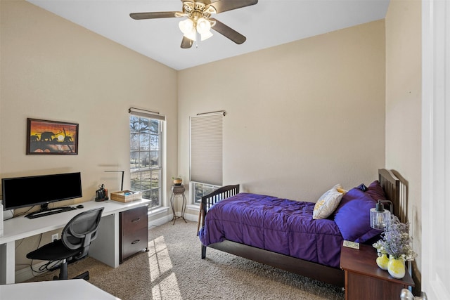 bedroom with a ceiling fan, light colored carpet, and baseboards