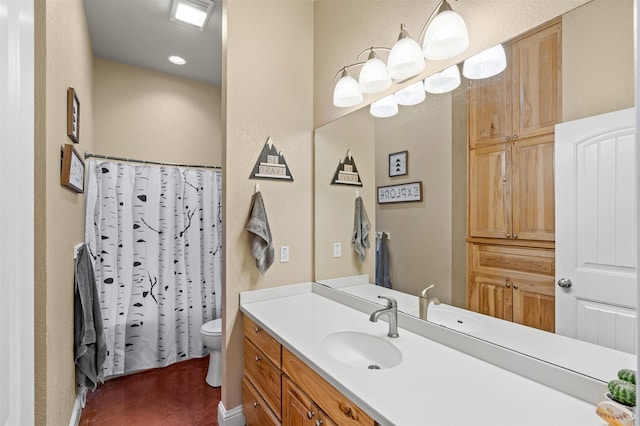 bathroom featuring curtained shower, toilet, and vanity