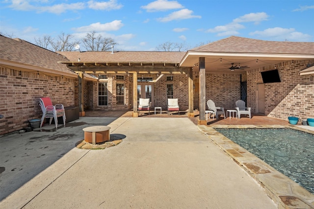 view of patio / terrace featuring ceiling fan and an outdoor fire pit