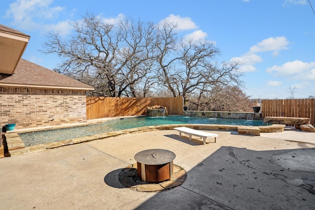 view of swimming pool featuring a patio, a fenced in pool, and a fenced backyard