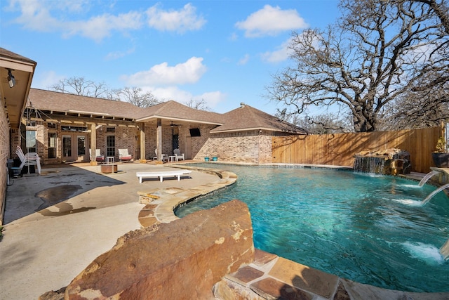 view of swimming pool featuring a patio area, a fenced in pool, a ceiling fan, and fence