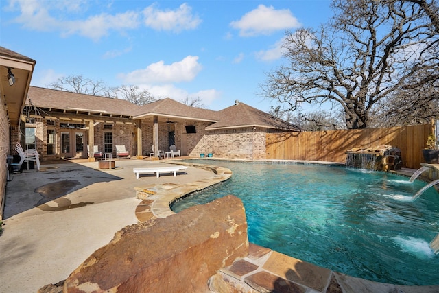 view of swimming pool featuring a patio area, a fenced in pool, ceiling fan, and fence