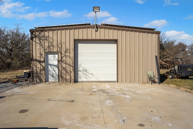 detached garage with concrete driveway