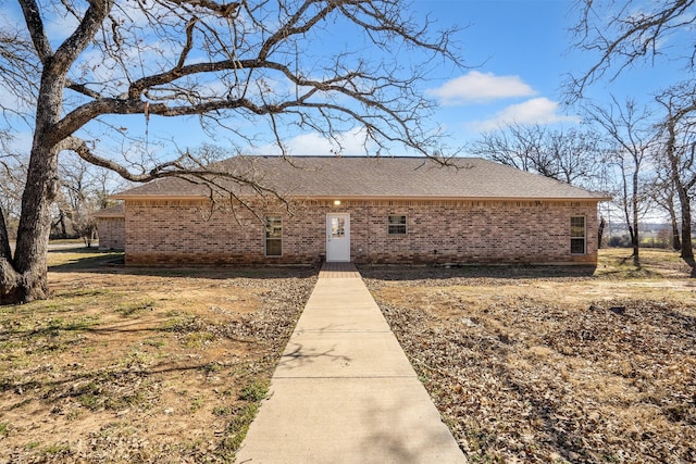 ranch-style house with brick siding and roof with shingles